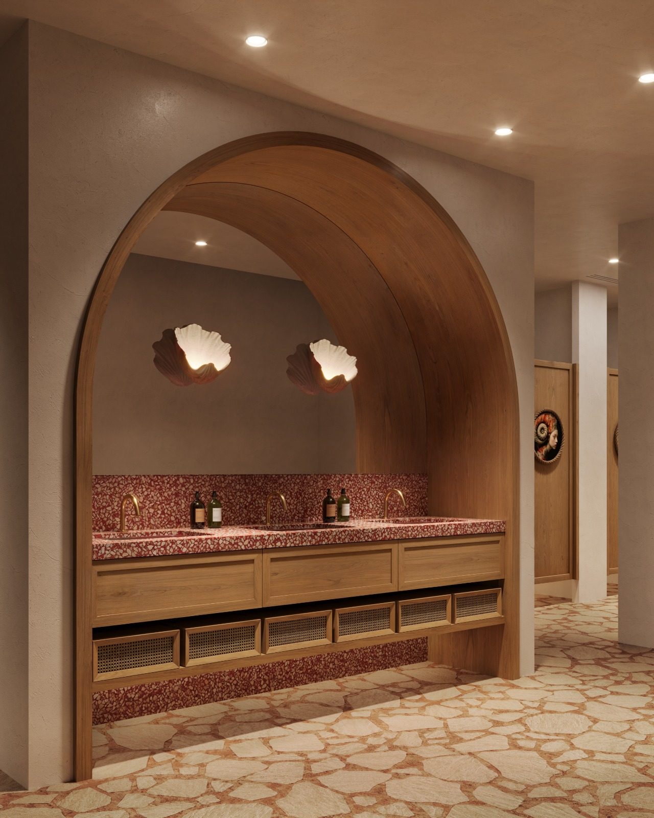 Terrazzo vanity under a wooden arch with shell sconces